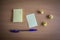 Collection of pins and note paper bunch and loose papers on wooden board. ball point pen. top view ready to fill your text and des