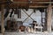 Collection of planers and retro wood saws hang on a wooden wall near an old house. Carpenters plane and other things on