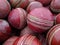 A collection of red leather cricket balls