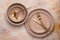 Collection of round beige plates of different sizes on the table, top view. Golden cutlery and crockery for serving and eating.