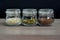 Collection of sesame, flax, pumpkin seeds in glass jars