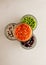 Collection set of various dried legumes in glass glasses stand in a pyramid: green peas, red beans, white beans close-up on a