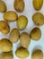 a collection of several ripe sapodilla fruits on a white background