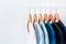 Collection shade of blue tone color t-shirts hanging on wooden clothes hanger in closet