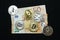Collection of silver and gold cryptocurrency coins on a 50 euro banknote