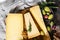 Collection of swiss, holland, french, italian cheeses with nuts and grapes. Dark background. Top view