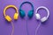 Collection of three headphones over purple background. Music concept.