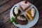 Collection of various cakes on wood background. Assortment of pieces slices with cream. Plate with different types of sweets.