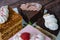 Collection of various cakes on wood background. Assortment of pieces slices with cream. Plate with different types of sweets.