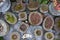 Collection of various evergreen plants and succulents in the garden on the mosaic table in homemade concrete containers