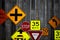 Collection of various road signs on rustic wooden wall