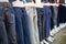 Collection of various types of blue jeans trousers, row of female mannequin in legs of womenâ€™s jeans of different colors,
