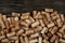 A collection of various used wine corks close-up. Plenty of sloping caps from alcoholic beverages