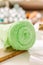 Collection of vibrant lime green knitted fabric rolls arranged in a neat pile