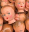 A collection of vintage doll faces