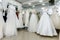 Collection of wedding dresses in showcase of the shop