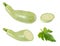 Collection of whole and sliced light green zucchini on white