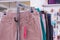 A collection of women\\\'s trousers hangs on a hanger on the counter. Large selection of casual wear