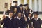 Collective photo of smiling boys and girls students university graduates celebrating getting diplomas