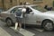 College boy with broken leg flagging down taxi, Paris, France