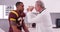 College football player having senior doctor review his concussion injury