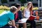 College friends studying together outdoors