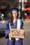 College Graduate Standing with Sign