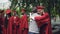 College professor is congratulating his student after graduation ceremony hugging him and shaking hand, teacher is proud