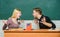 College relations. Relations classmates. Students communicate classroom chalkboard background. Violence and bullying