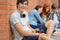 College student boy sitting ground with friends