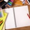 College student desk with blank writing book, copy space