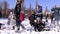 College students campus snowball fight at sunny winter day.