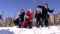 College students campus snowball fight at sunny winter day.