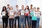 College students holding question mark signs