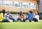 College students sitting and talking on lawn