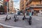 Collegno, Italy. February 15th, 2021. Group of electric kick scooters parked on a sidewalk. Gathering station with parking sign