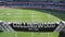 Collingwood Magpies supporter scarf with blurred background view of Melbourne Cricket Ground field during a footy game