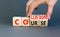 Collision course symbol. Concept word Collision course on wooden cubes. Beautiful grey table grey background. Businessman hand.