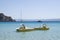 Coloful water wheels with slide, motorboat and yacht in a quiet bay Simos in Greece