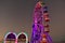 Colofur arches and Ferris Wheel on sunset background at Old Town Kissimmee in 192 Highway area.