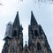 Cologne Cathedral with scaffold against cloudy sky