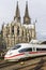 COLOGNE, GERMANY - April 7 2018: Rear view of Cologne railway station with white ICE train. Cathedral tower on background