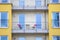 Cologne, NRW, Germany, 05 03 2021, facade of an apartment buidling with balconies and two chairs and a table on it