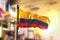 Colombia Flag Against City Blurred Background At Sunrise Backlight