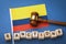 Colombia flag, judge`s gavel and wooden cubes with text, concept on the theme of sanctions