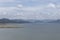 Colombia Guatavita Tomine reservoir blue lake with mountains and blue cloudy sky