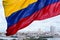 Colombian flag waving on the wind and modern Cartagena district