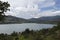 Colombian guavio reservoir lake landscape with andean mountain range and blue cloudy sky