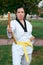 Colombian and Latin American woman practicing taekwondo defense with nunchakus in defense position right side