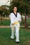 Colombian, Latin American woman practicing taekwondo with nunchakus right defense down